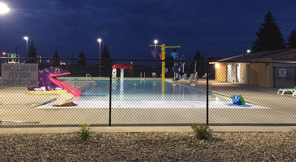 Night time view of the Tioga Municipal Pool's outdoor lap/leisure pool